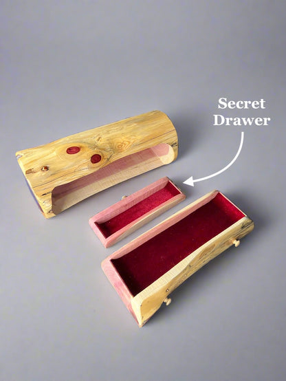 Wooden box with a secret drawer on a gray background