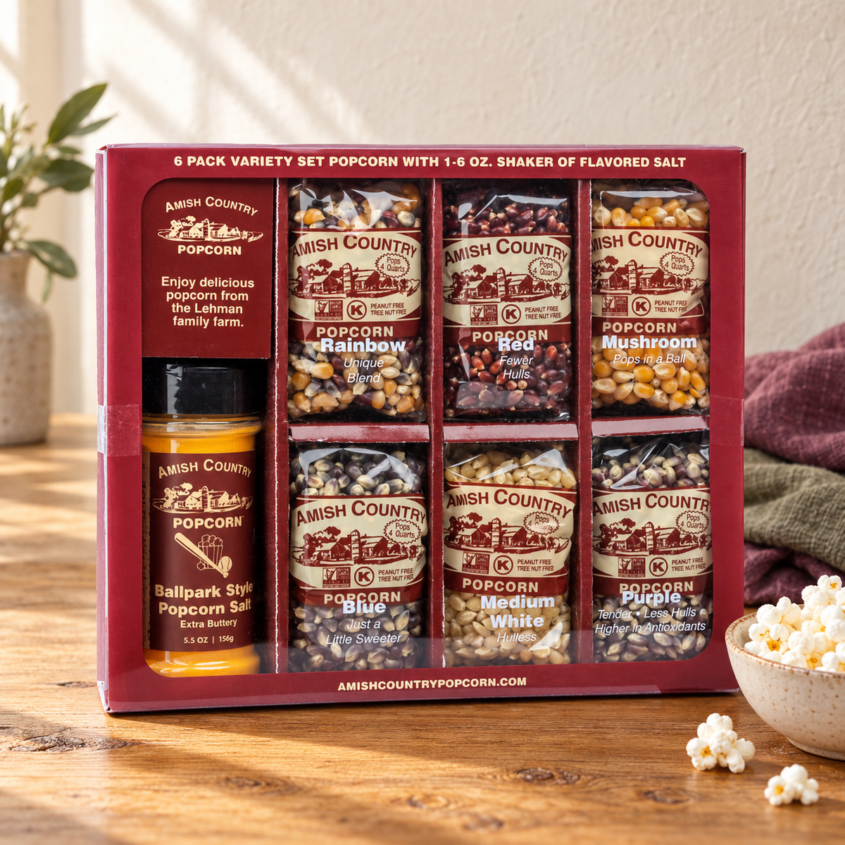 Amish Country Popcorn Six-Pack Variety Set six kernel bags with one seasoning-salt shaker beside popcorn on a wooden table