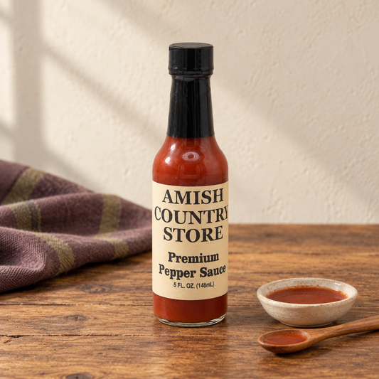 Amish Country Store Premium Pepper Sauce, 5 fl oz bottle beside a small serving