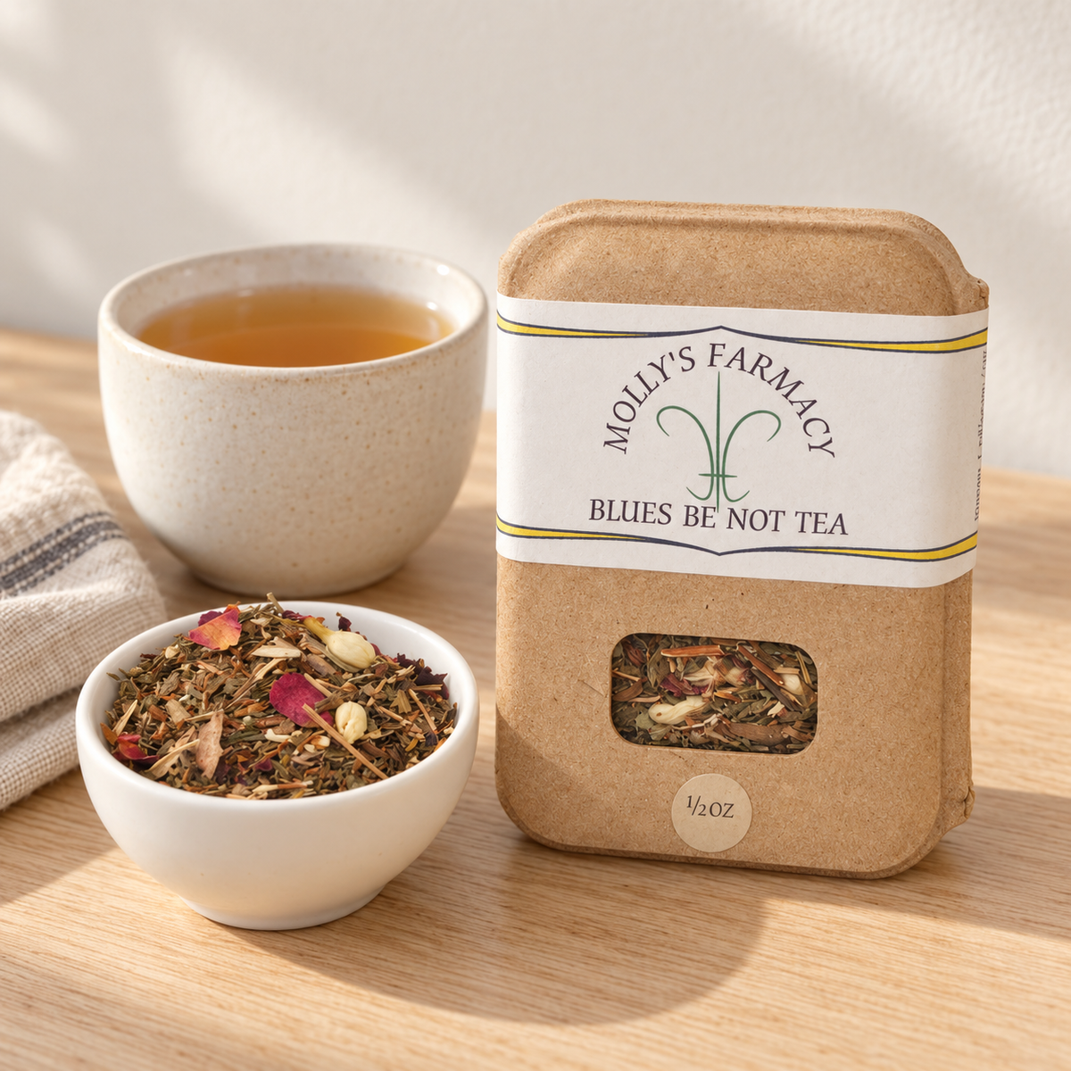 Molly's Farmacy Blues Be Not Tea, 1/2 oz, beside loose tea and a cup. Styled scene based on the genuine product photo.