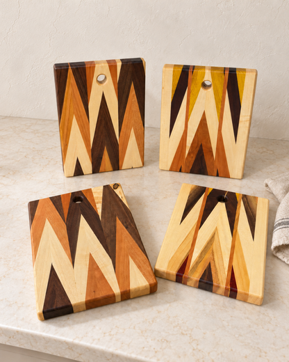 Four Amish-made chevron boards show examples of natural wood variation in a styled kitchen setting; one board per purchase.