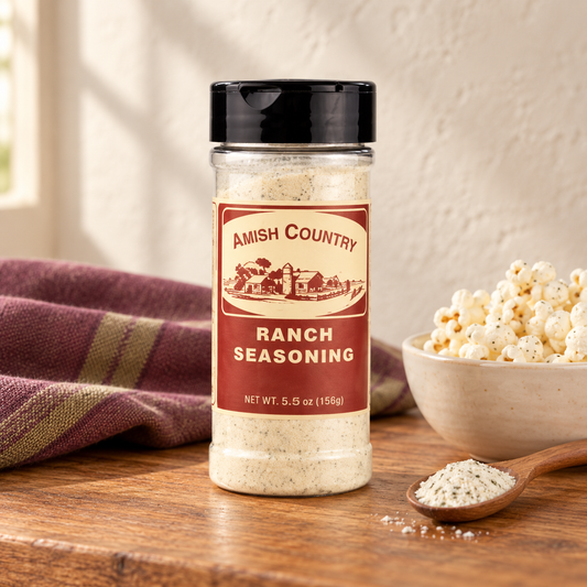 Ranch Popcorn Seasoning 5.5 oz beside popcorn on a wooden table
