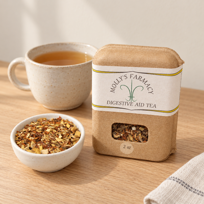Molly's Farmacy Digestive Aid Tea, 2 oz, beside loose tea and a cup. Styled scene based on the genuine product photo.