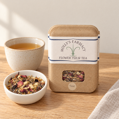 Molly's Farmacy Flower Tulsi Tea, 1/2 oz, beside loose tea and a cup. Styled scene based on the genuine product photo.