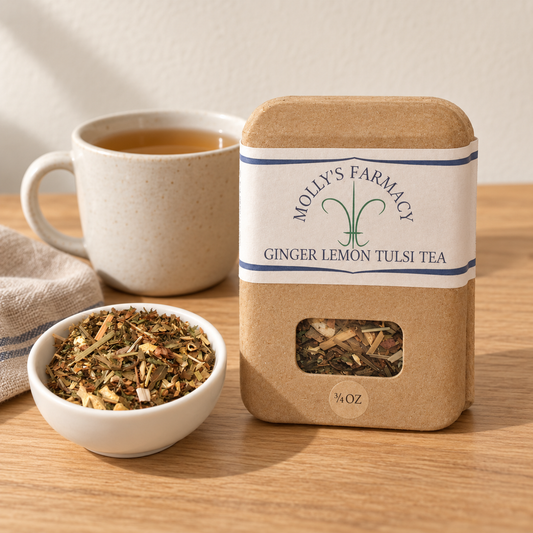 Molly's Farmacy Ginger Lemon Tulsi Tea, 3/4 oz, beside loose tea and a cup. Styled scene based on the genuine product photo.