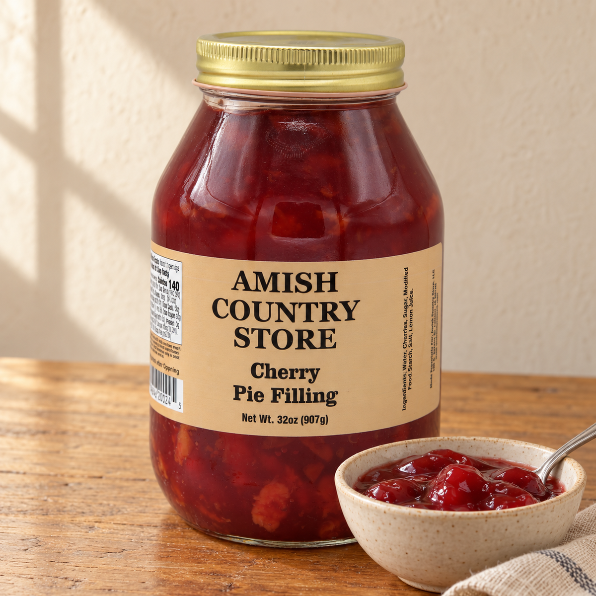 Amish Country Store Old-Fashioned Cherry Pie Filling jar beside a serving of its contents.