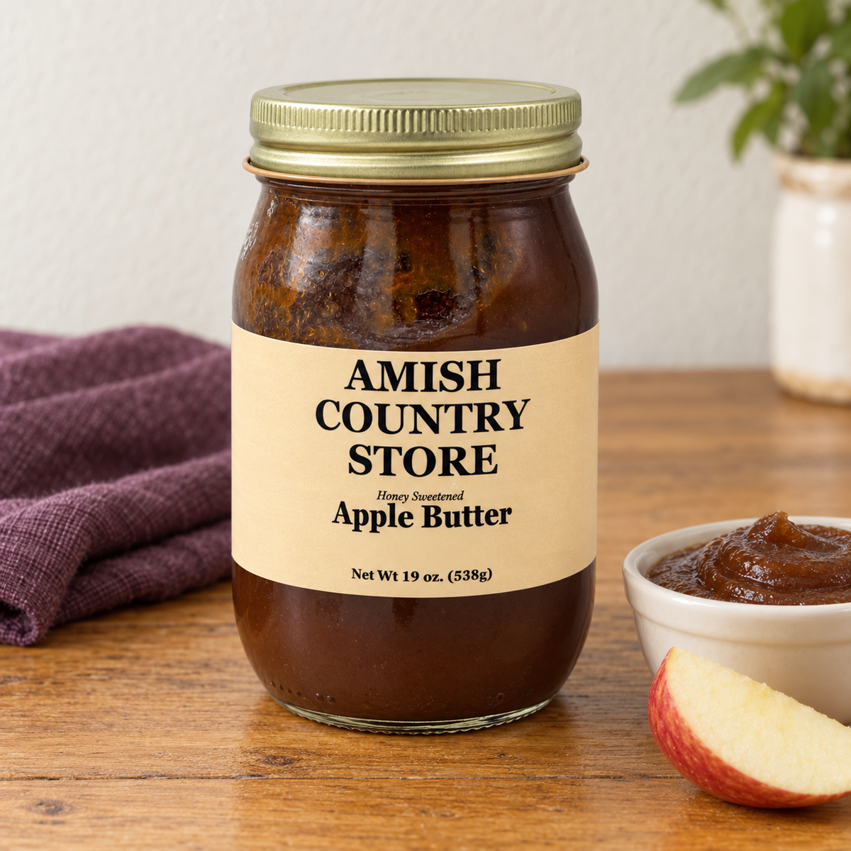 Amish Country Store Honey Sweetened Apple Butter 19 oz jar, with smooth apple butter and an apple wedge.