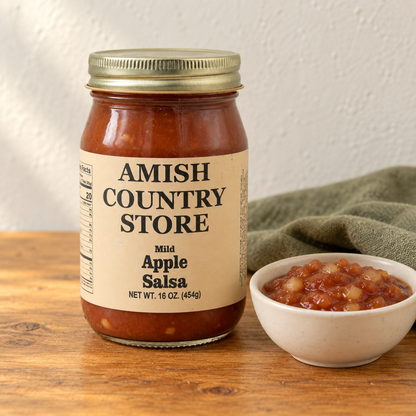 Apple Salsa in its original labeled jar with a small serving beside it on a warm wood table.
