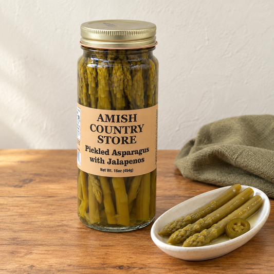 Amish Country Store Pickled Asparagus with Jalapeños, 16 oz jar beside whole pickled asparagus spears.