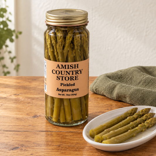 Amish Country Store Pickled Asparagus, 16 oz jar beside whole pickled asparagus spears.