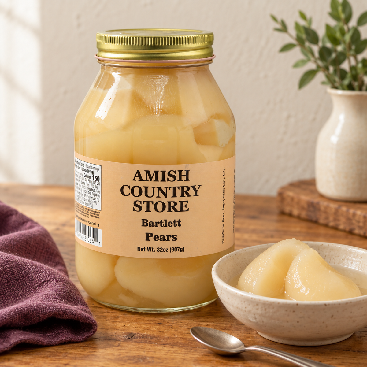 Amish Country Store Bartlett Pears, 32 oz (907g) jar, beside a small serving matching its contents.