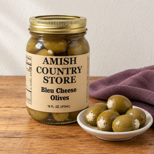 Amish Country Store Bleu Cheese Olives, 16 fl oz jar, beside a small serving of cheese-filled green olives.