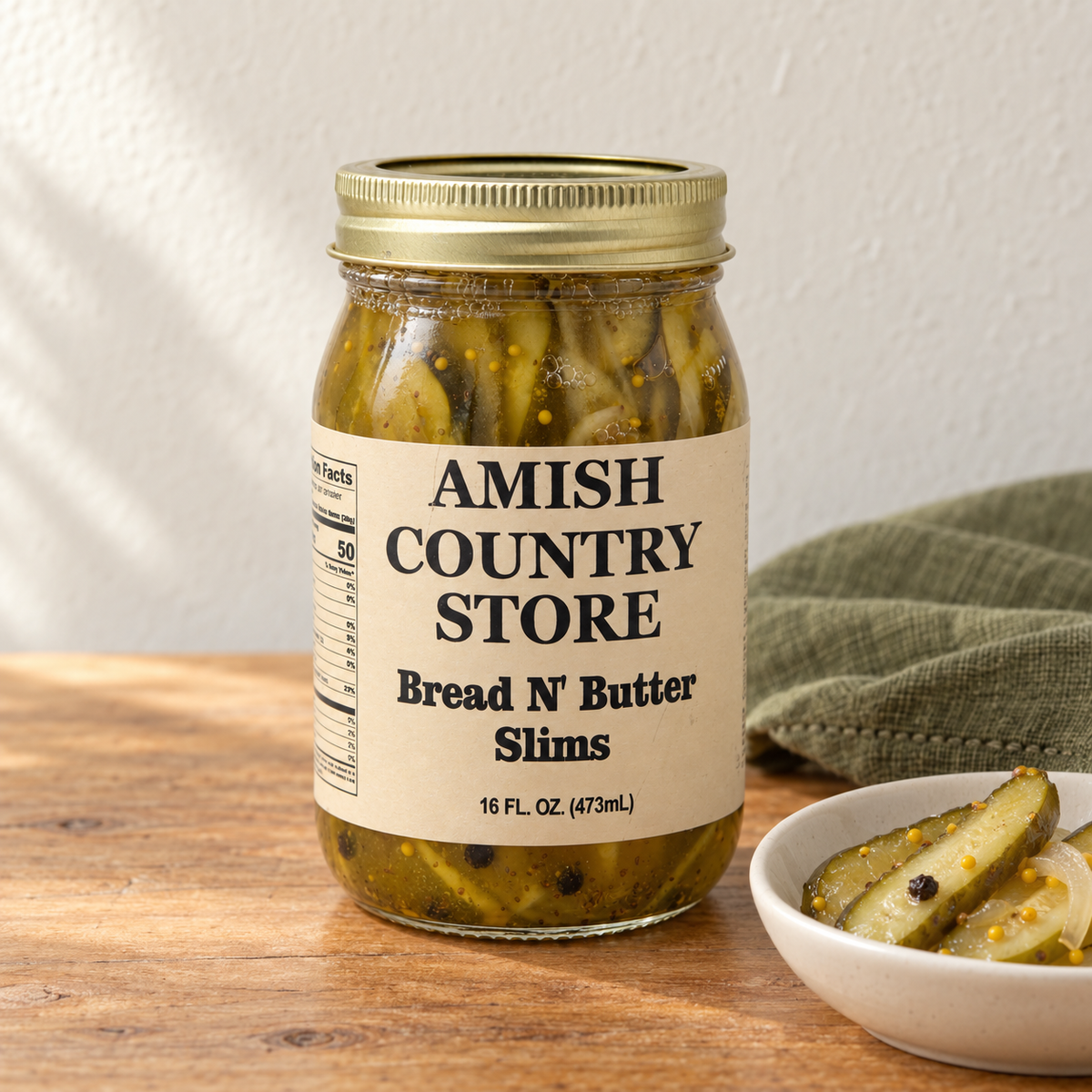 Bread ’N Butter Slims in its original labeled jar with a small serving beside it on a warm wood table.