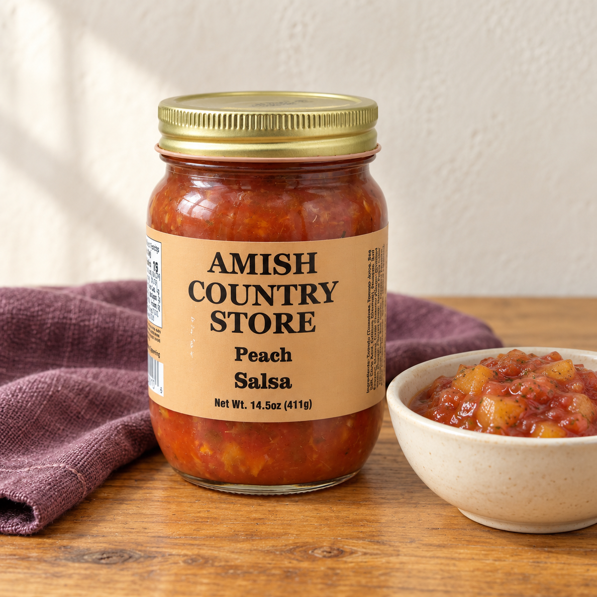 Old-Fashioned Peach Salsa in its original labeled jar with a small serving beside it on a warm wood table.