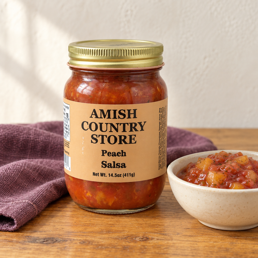 Old-Fashioned Peach Salsa in its original labeled jar with a small serving beside it on a warm wood table.