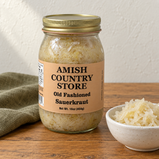 Amish Country Store Old Fashioned Sauerkraut, 16 oz jar beside a bowl of shredded cabbage sauerkraut.