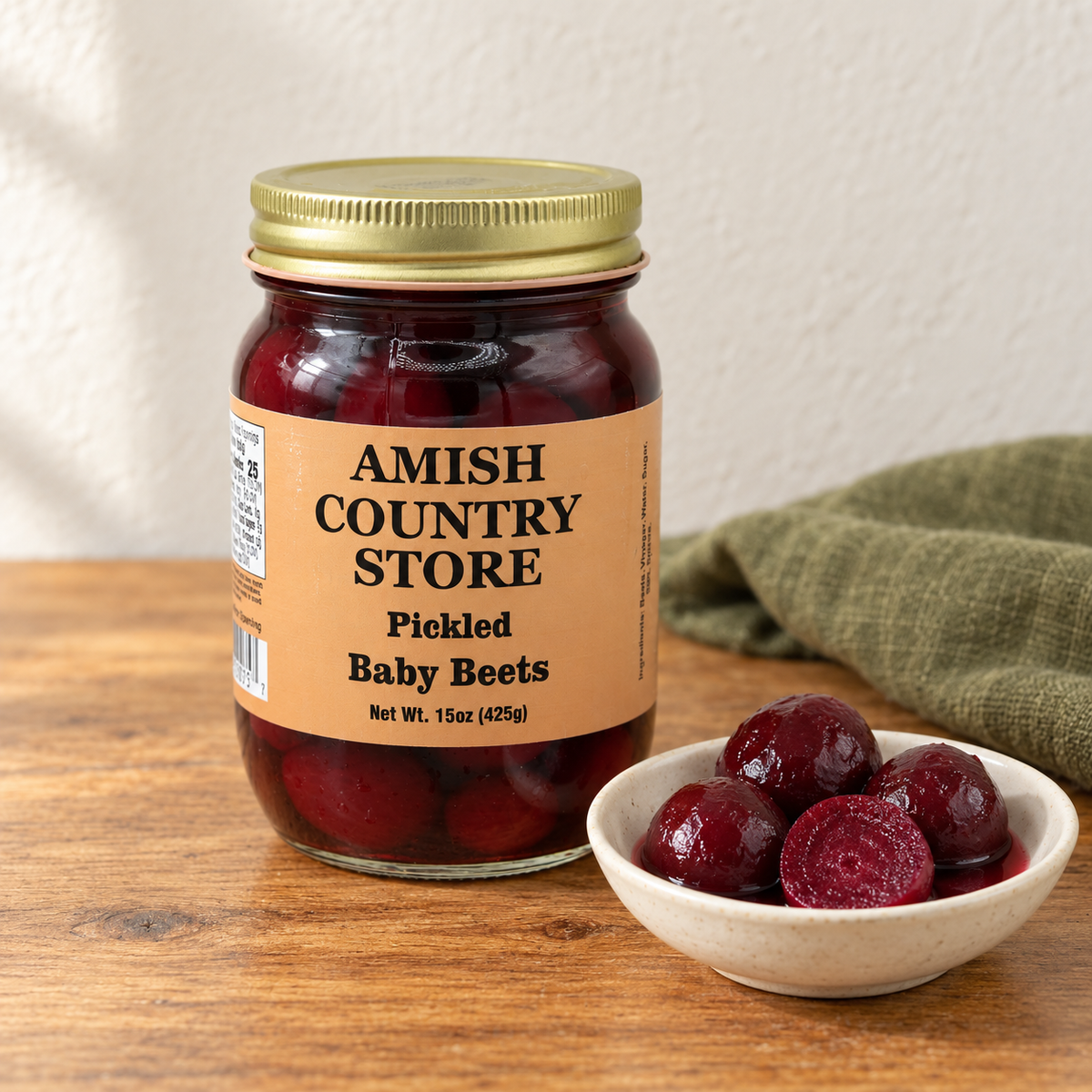 Amish Country Store Pickled Baby Beets, 15 oz jar with whole ruby pickled beets served beside it.