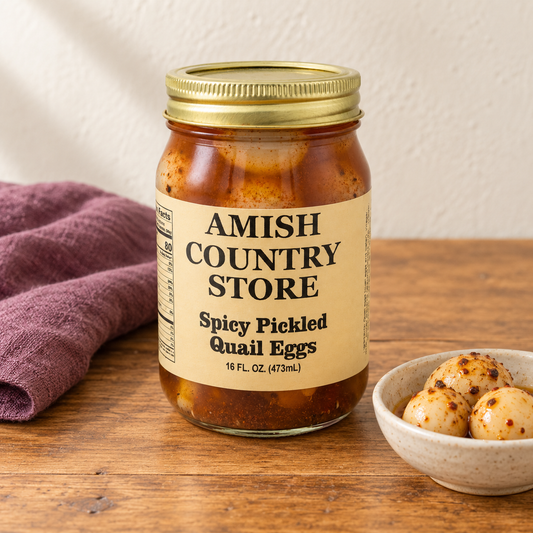 Spicy Pickled Quail Eggs in its original labeled jar with a small serving beside it on a warm wood table.