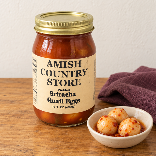 Sriracha Quail Eggs in its original labeled jar with a small serving beside it on a warm wood table.