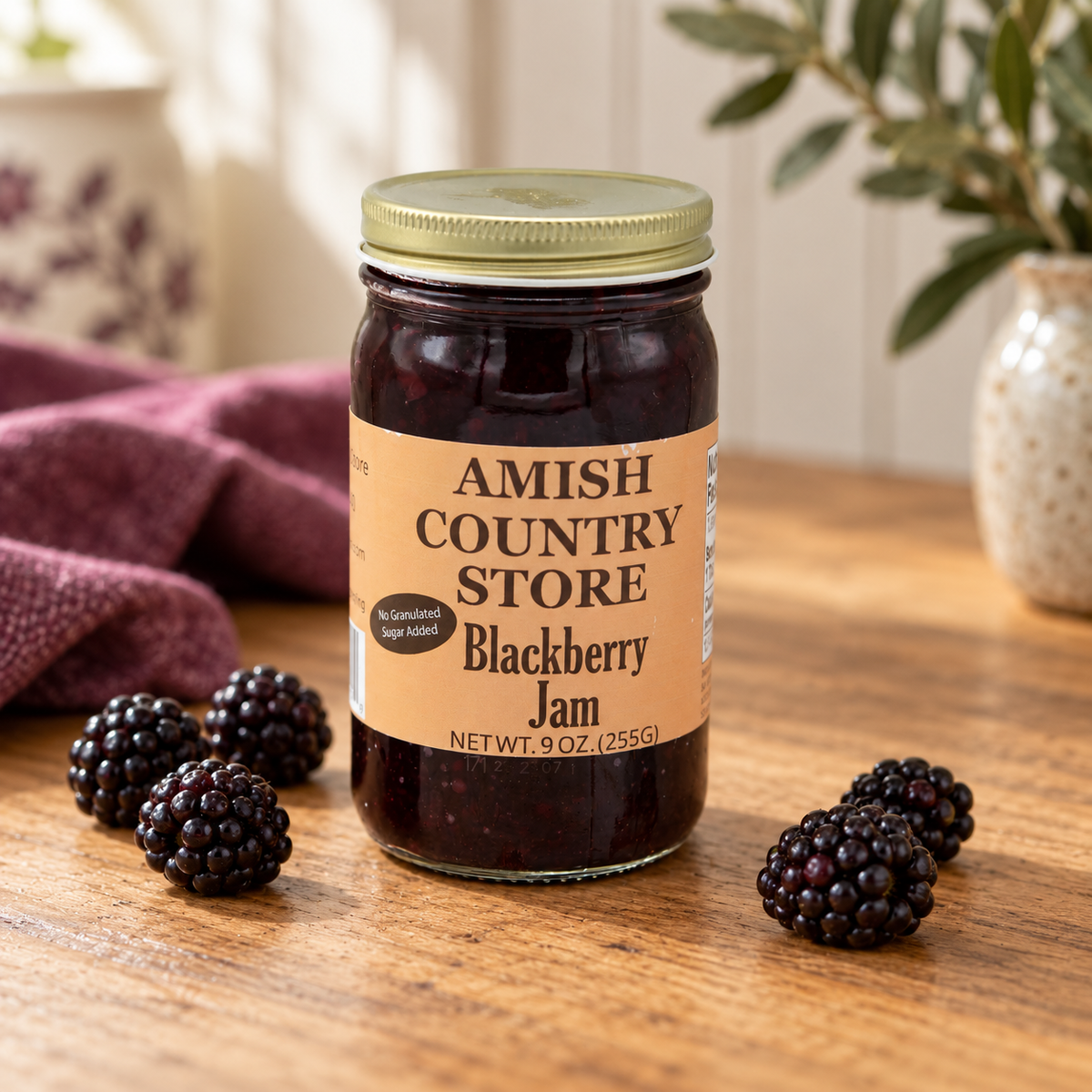 Juice-sweetened blackberry jam, 9 oz jar, beside fresh blackberries.