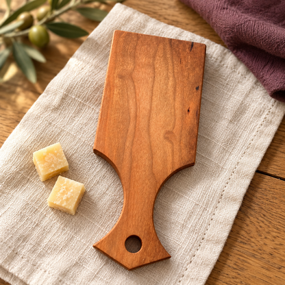 One solid-wood Amish-made mini cheese board with paddle handle.