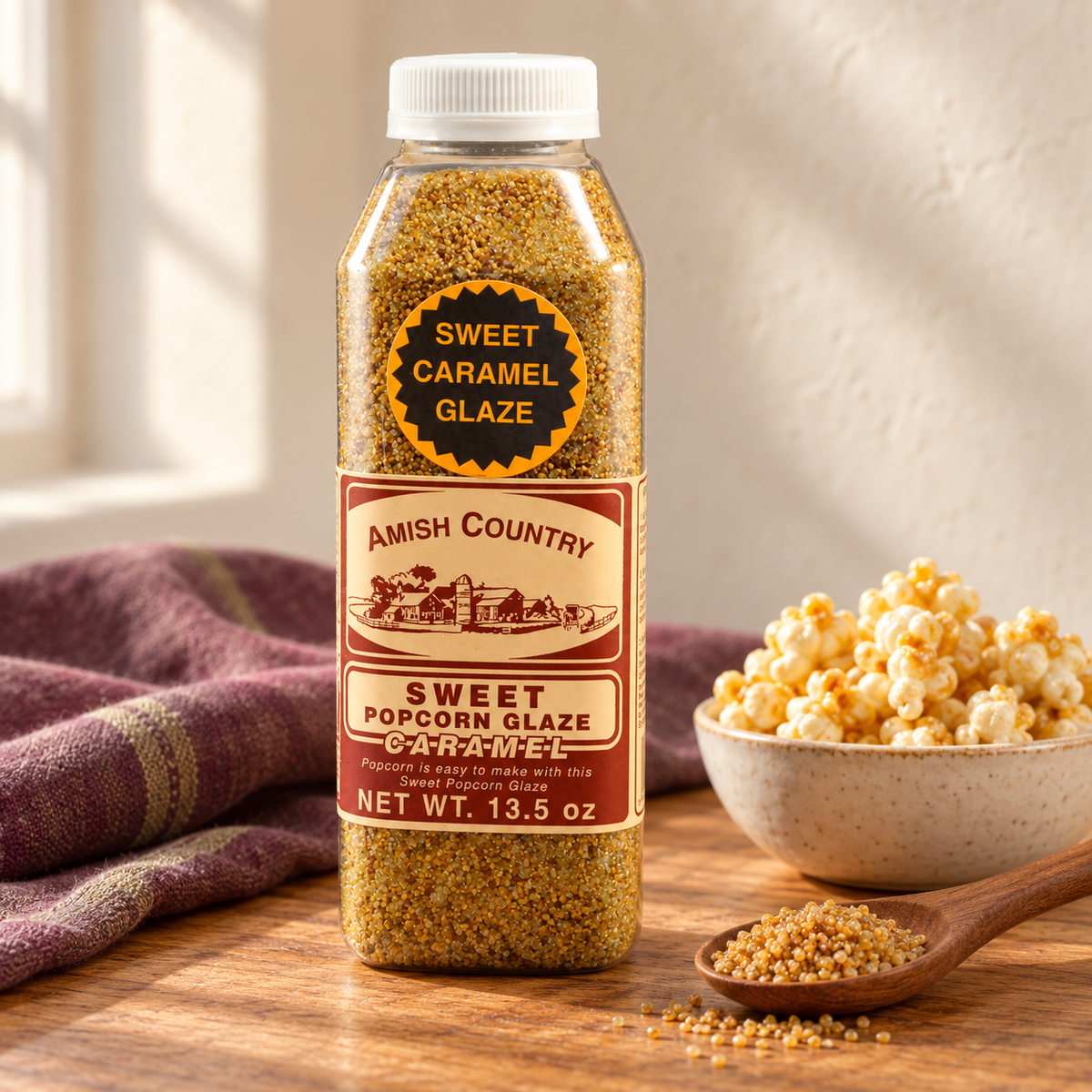 Sweet Caramel Popcorn Glaze 13.5 oz beside popcorn on a wooden table
