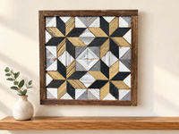 S1143 — small wooden barn quilt wall art, gold and charcoal corner stars with white diamond center, displayed on an indoor wall in a styled home
