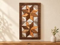 S6 — small horizontal two-star wooden barn quilt wall art, natural honey and dark brown stars on weathered white triangles, displayed on an indoor wall in a styled home