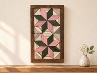 S8 — small horizontal two-star wooden barn quilt wall art, pink and dark green stars on white triangles, displayed on an indoor wall in a styled home
