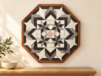 S1216 — wooden barn quilt wall art, OCTAGONAL gray, charcoal and white geometric flower with four inner stars, shown on an indoor wall in a styled home display
