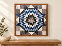 S1220 — wooden barn quilt wall art, square navy blue, light blue, ivory and charcoal starburst, displayed on an indoor wall in a styled home