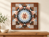 S1228 — wooden barn quilt wall art, square light blue, dusty rose, ivory and charcoal starburst, displayed on an indoor wall in a styled home
