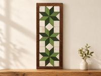 S12 — horizontal three-star wooden barn quilt wall art, three light green and forest green stars on ivory squares, displayed on an indoor wall in a styled home