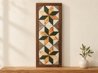 S14 — horizontal three-star wooden barn quilt wall art, three forest green and natural honey wood stars on weathered white and gray triangles, displayed on an indoor wall in a styled home