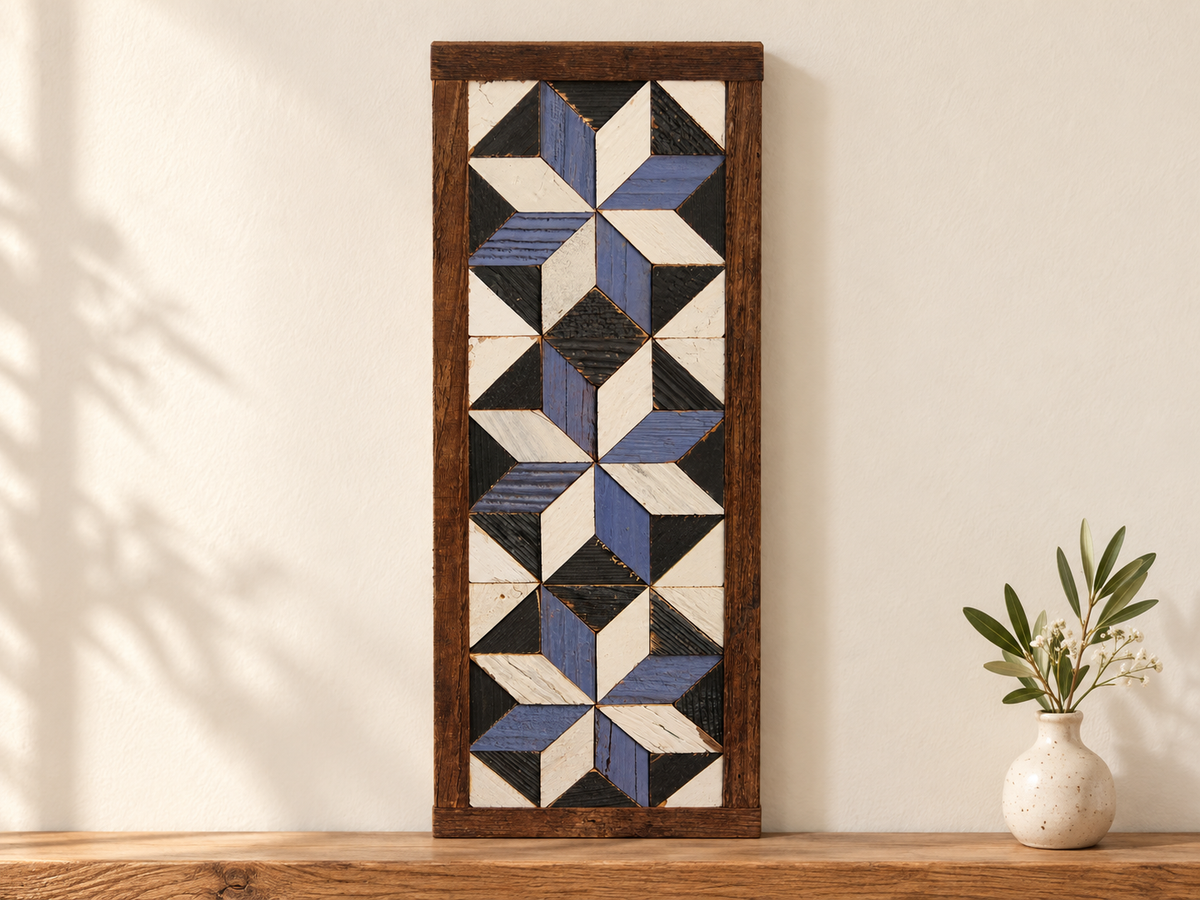 S3 — horizontal three-star wooden barn quilt wall art, three muted periwinkle and ivory stars on black and white triangles, displayed on an indoor wall in a styled home