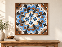 S1183 — 30.5 inch Amish reclaimed wood barn quilt, blue, white, charcoal and natural wood geometric flower with four small blue-and-black stars around the center, displayed on an entryway wall above an oak console