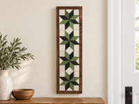 S6 — horizontal four-star wooden barn quilt wall art, four light green and black stars on ivory squares, displayed on an indoor wall in a styled home