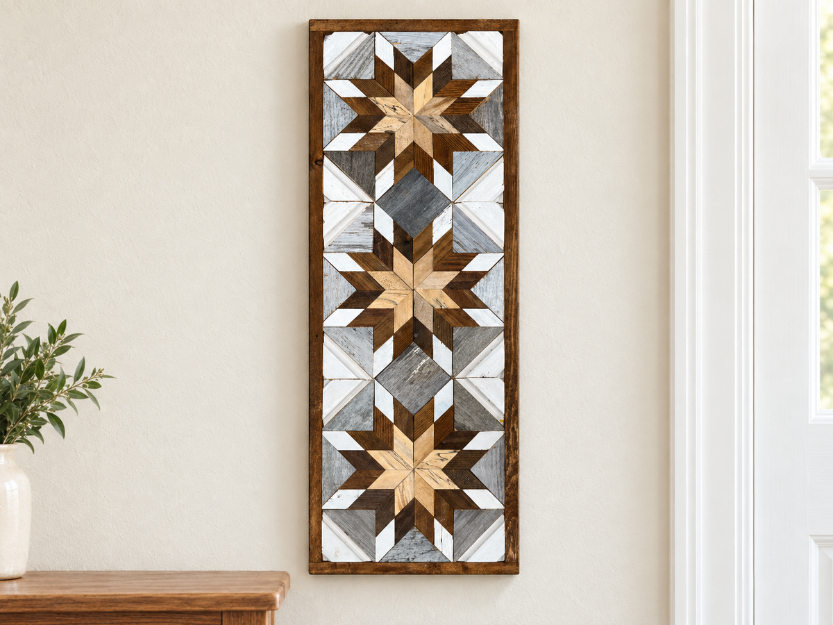 S1129 — tall wooden barn quilt banner wall art, three stacked starbursts with natural wood centers, brown middles and white tips with gray diamonds between, displayed on an indoor wall in a styled home