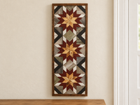 S1213 — tall wooden barn quilt banner wall art, three natural wood center stars, burgundy middle points, white tips, gray field and black corner diagonals, displayed on an indoor wall in a styled home