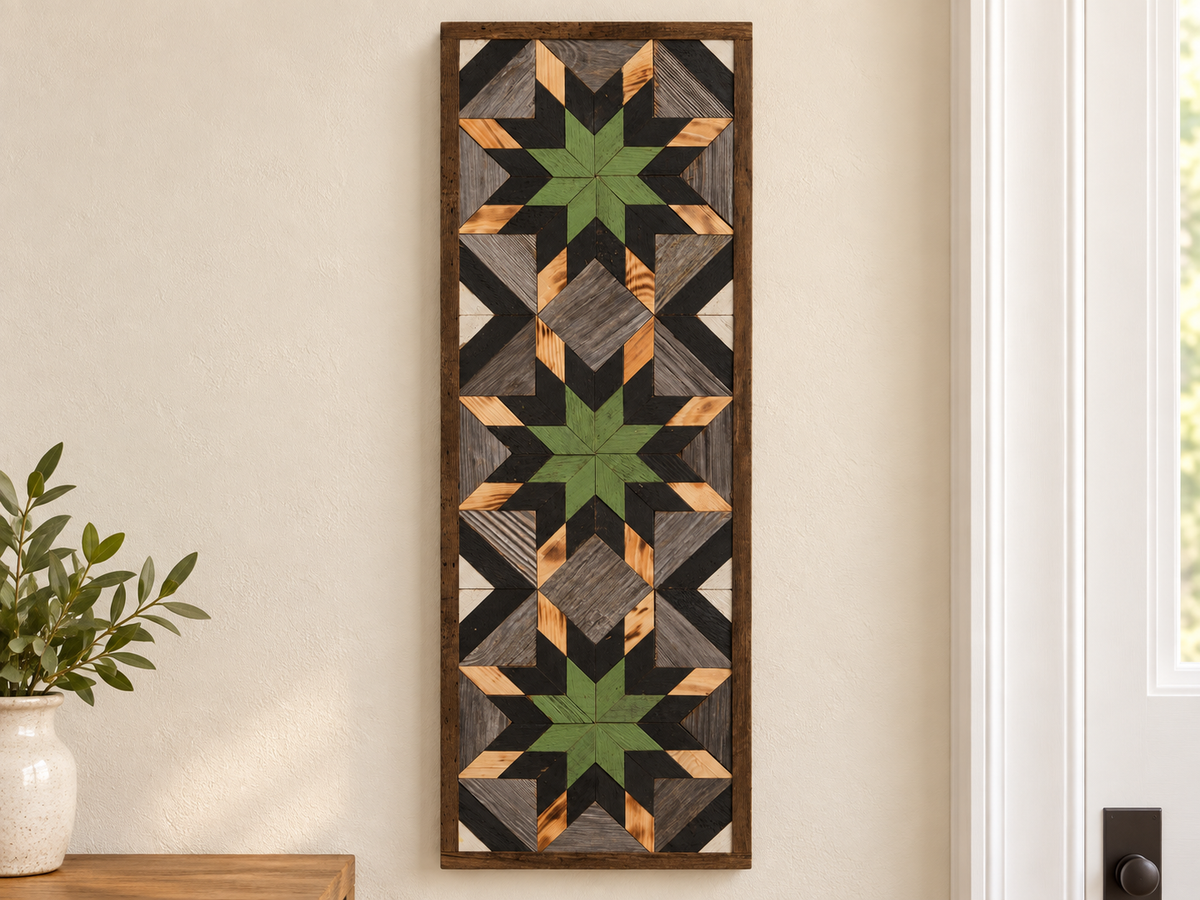 S1215 — tall wooden barn quilt banner wall art, three green center stars, black middle points, natural wood tips, gray field and black diagonals, displayed on an indoor wall in a styled home