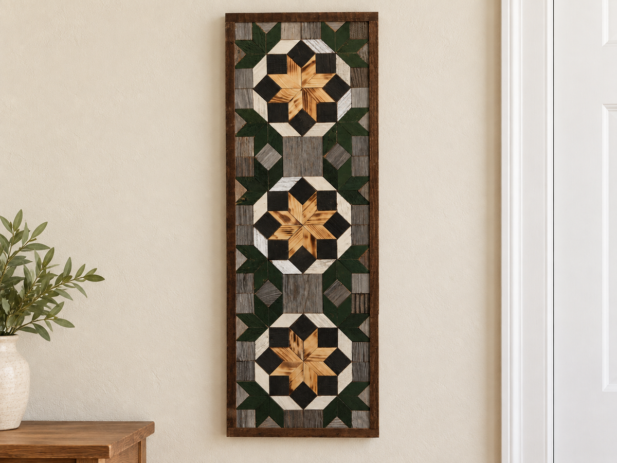 S1217 — tall wooden barn quilt banner wall art, three natural wood center flowers, black blocks, white rings, partial forest green corner stars and gray field, displayed on an indoor wall in a styled home