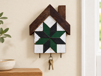 KH-02 — house-shaped wooden barn quilt key holder with exactly three existing metal hooks, KH-02 Green & Black, displayed beside an entryway