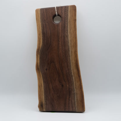 Wooden cutting board with a hole for hanging on a white background