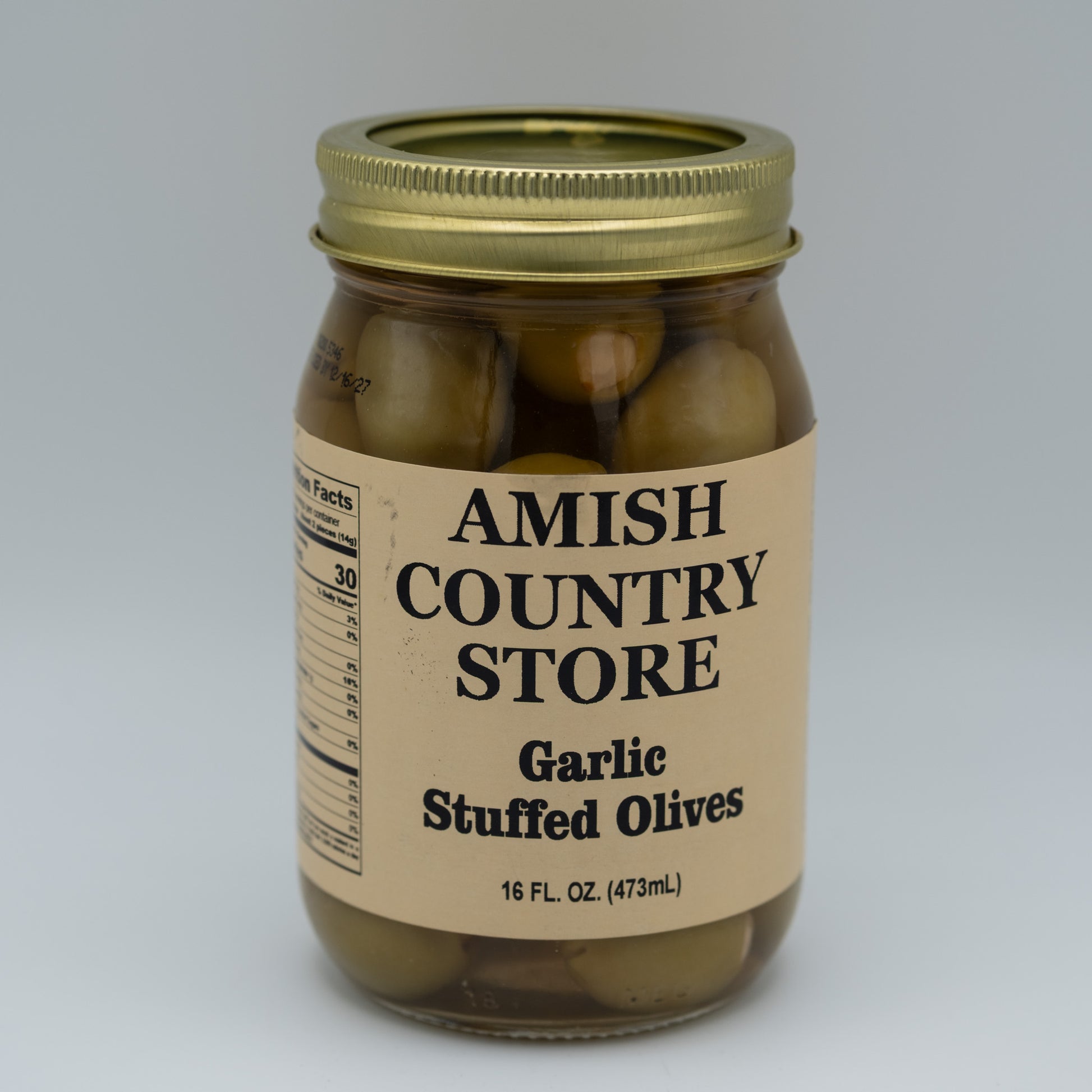 Jar of garlic stuffed olives from Amish Country Store on a gray background