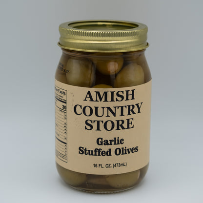 Jar of garlic stuffed olives from Amish Country Store on a gray background