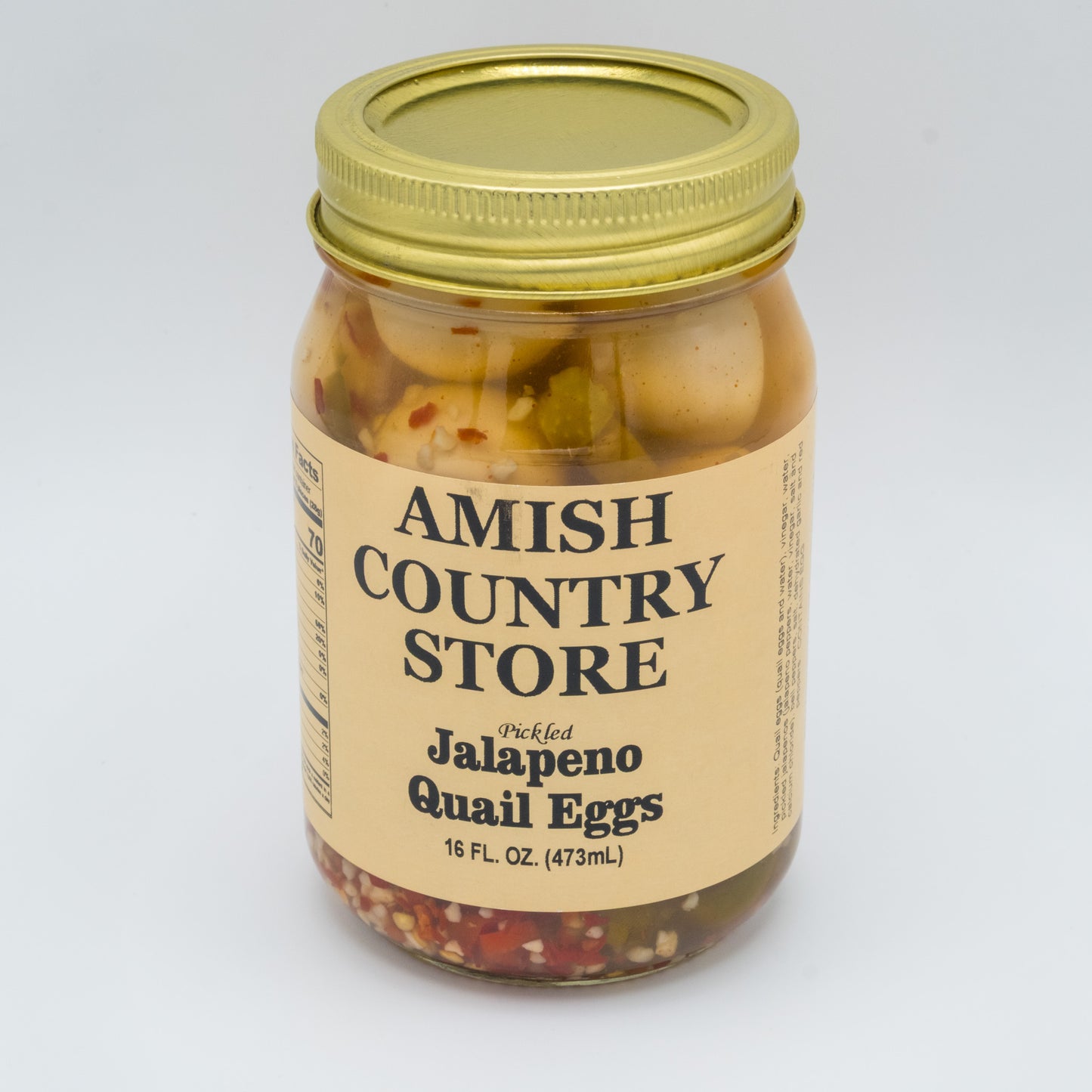 Jar of Amish Country Store jalapeno quail eggs on a white background