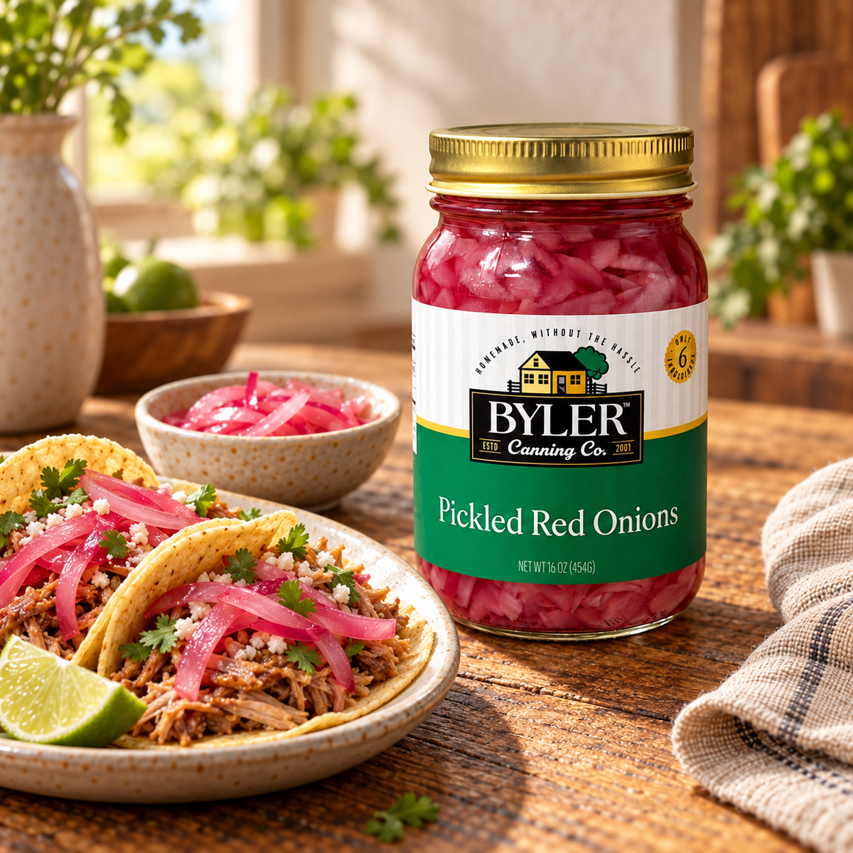 Byler Pickled Red Onions jar beside tacos topped with rosy pickled onions on a rustic table.