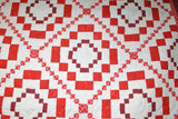 close up of diamond quilt square with white and red layered diamonds